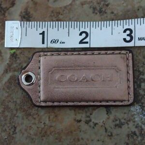 COACH BRONZE COLORED LEATHER HANG TAG